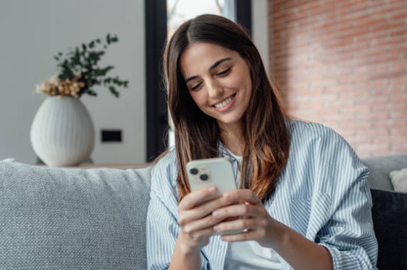 Pessoa usando o celular em um ambiente acolhedor
